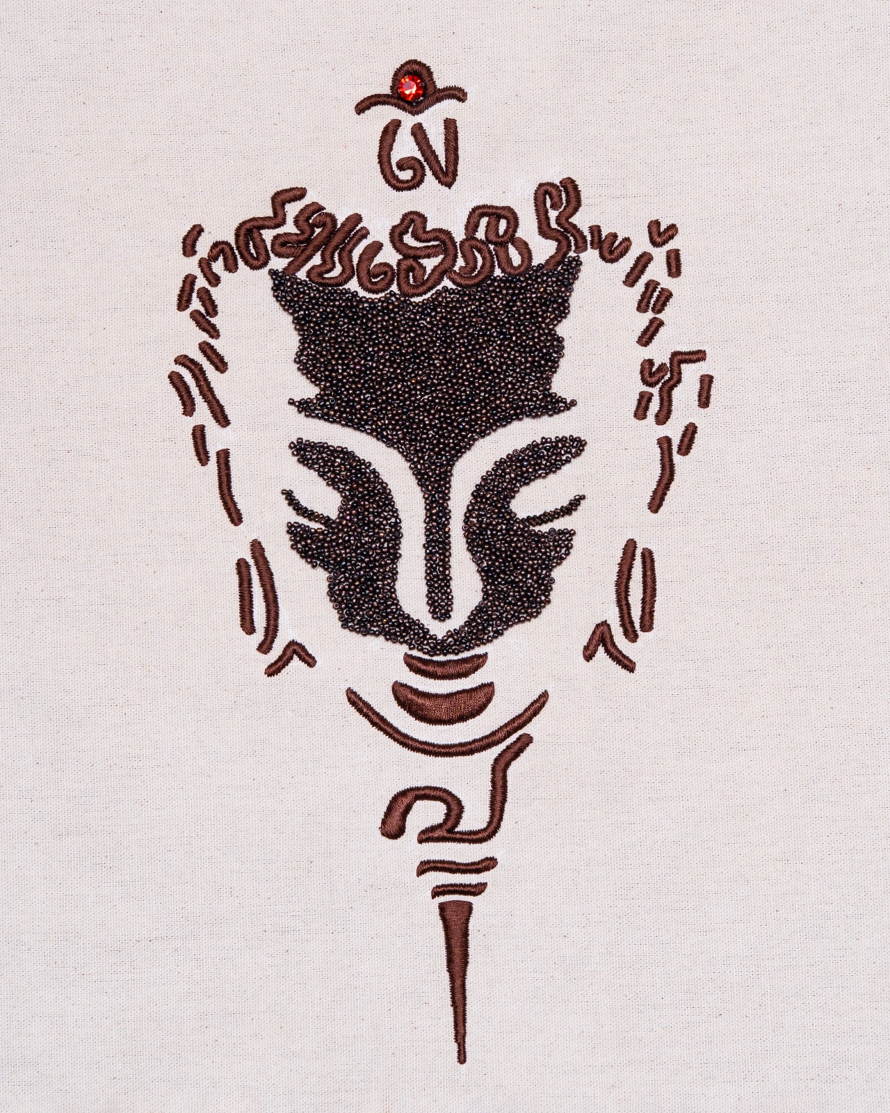Buddha in bead and thread on natural linen