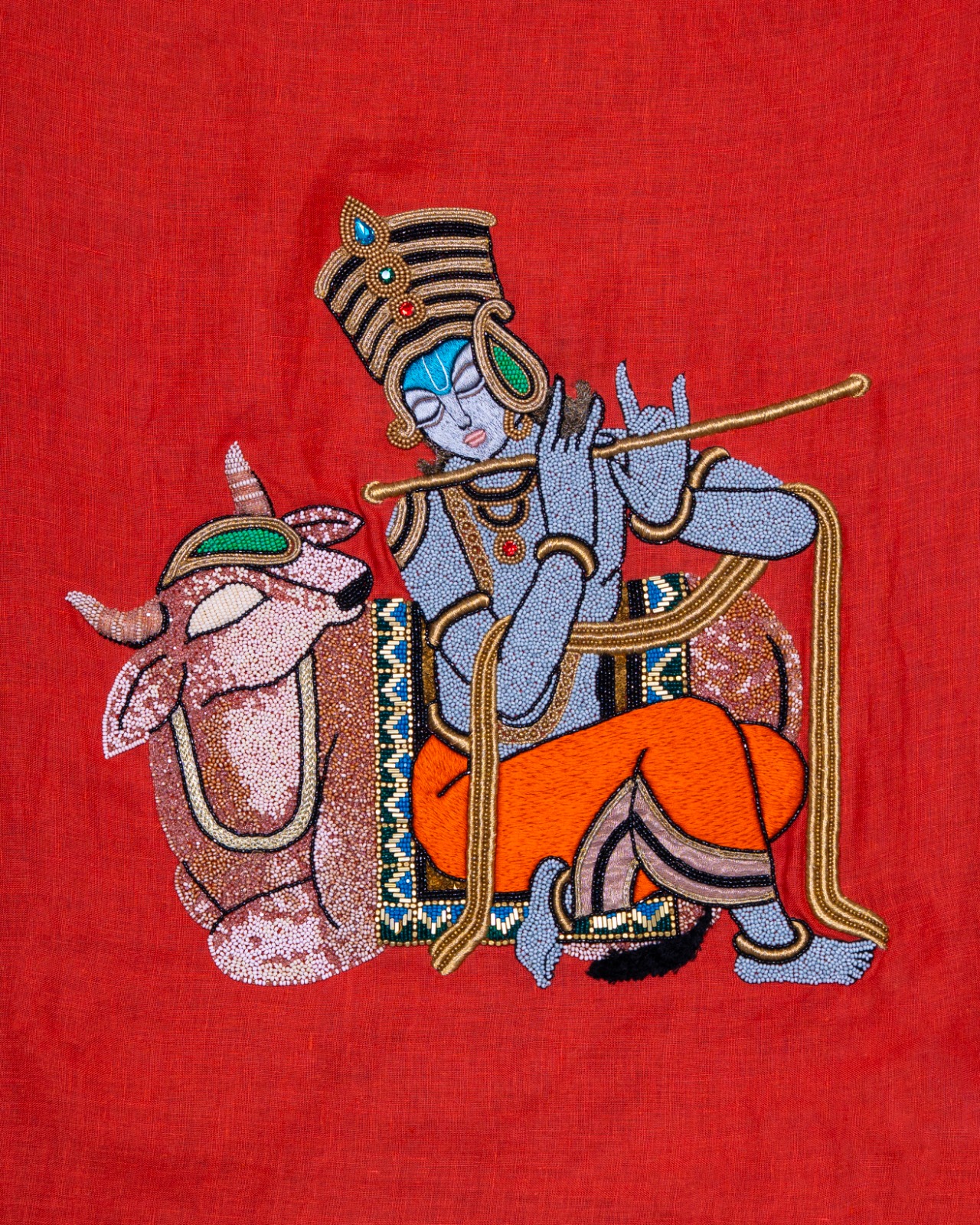 Krishna with Kamadhenu, hand-beaded on red linen